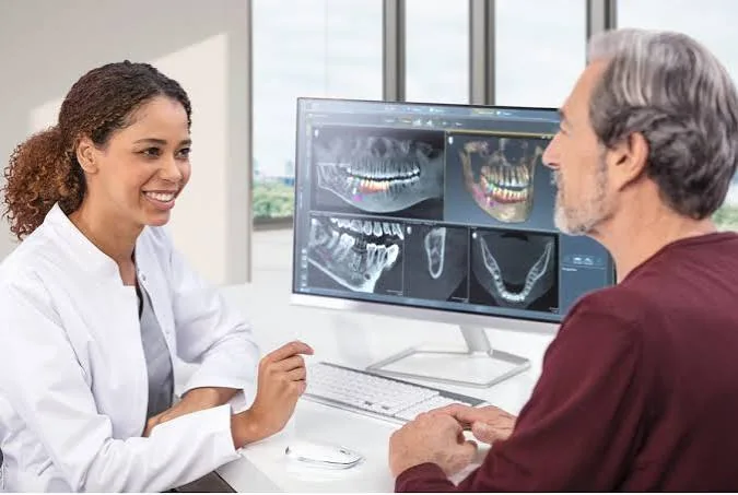 Specialist reviewing a patient's radiology report on screen
